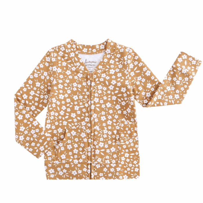 The Jammie Session Honey Blooms Kids' Jacket (runs small, please size up) features light brown cotton fabric, a white floral print, two front pockets, and zipper closure. One sleeve is raised against a white background.
