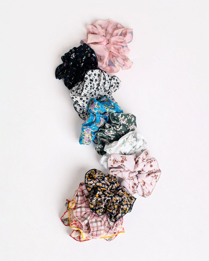 Nine Handmade Scrunchies by Jammie Session, including a silk option, arranged vertically on a white background‚Äîideal for work-at-home moms who want stylish and comfortable hair accessories.