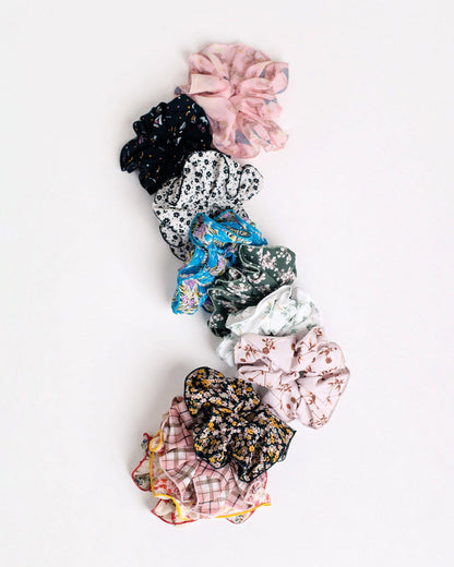Nine Handmade Scrunchies by Jammie Session, including a silk option, arranged vertically on a white background‚Äîideal for work-at-home moms who want stylish and comfortable hair accessories.