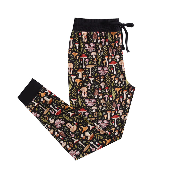 The Jammie Session Mystic Mushrooms Women's Jogger Pants feature a soft black fabric with an elastic waistband, drawstring, and colorful mushroom and foliage pattern‚Äîperfect for stylish, comfortable lounging at home.