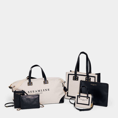 Designer travel set of The Navigator handbag in sustainable canvas and black leather with gold trims